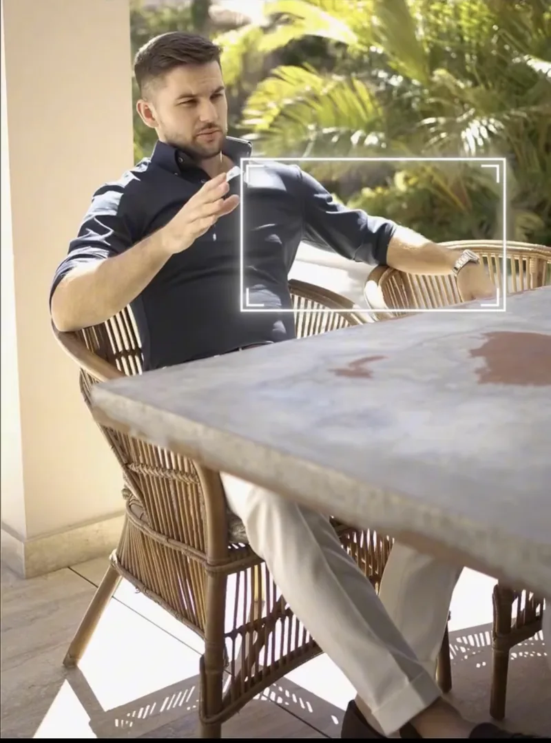 Open, confident seated gesture